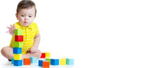 interested infant playing with building blocks